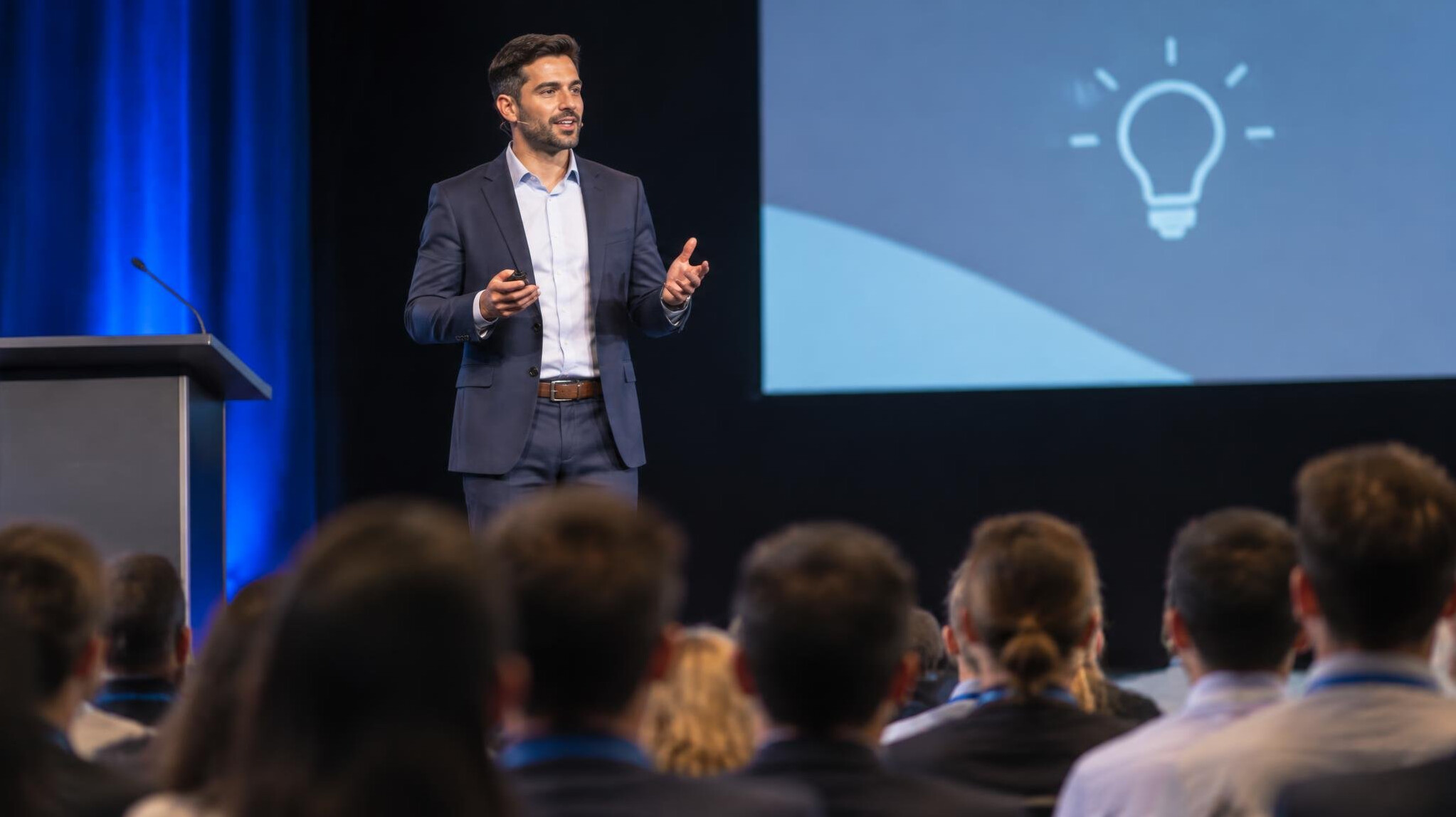 person delivering speech on stage